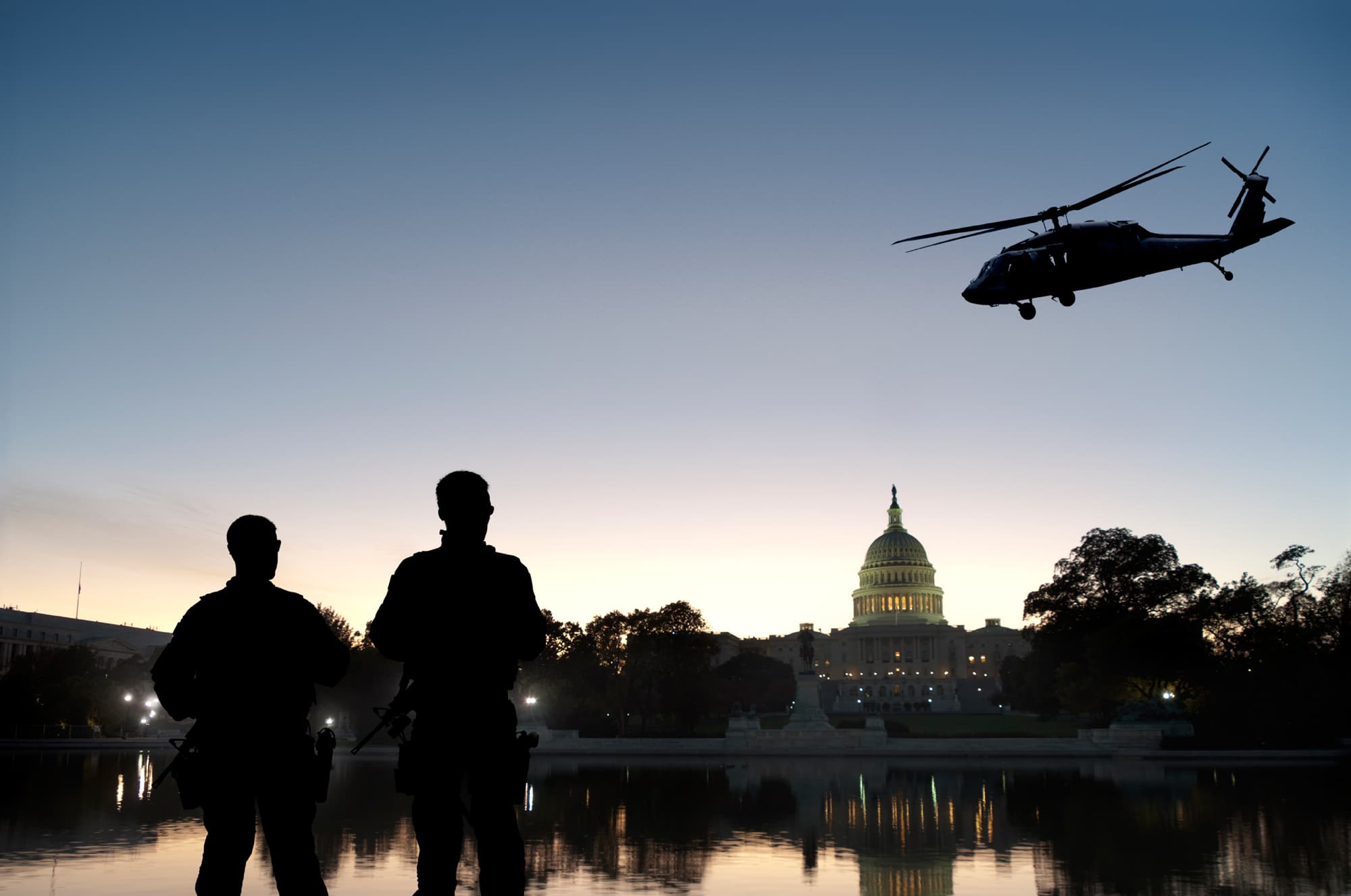 two soldiers overlooking white house with helicopter on the background