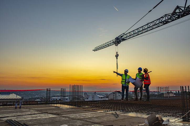 Is a Master’s in Construction Management Worth It? Three construction managers leading a project at a work site.