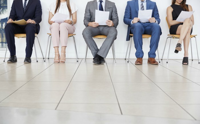 Job candidates sitting in a waiting room ahead of a job interview