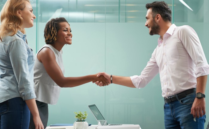Business professionals greeting each other with a handshake during an interview