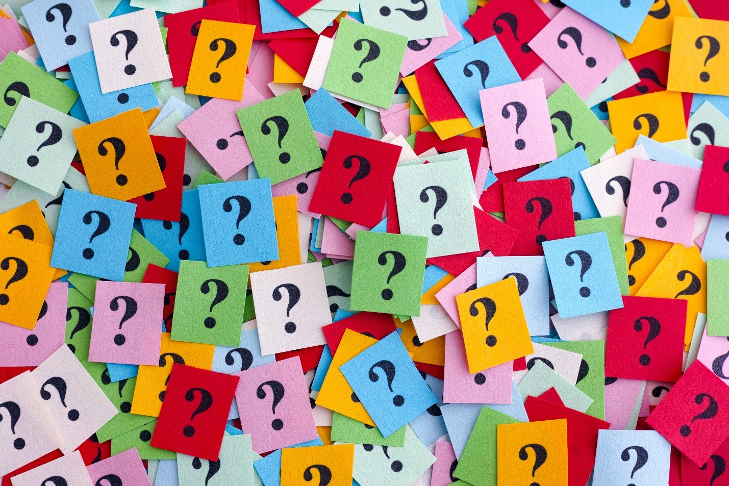 A board of colorful sticky notes with question marks 