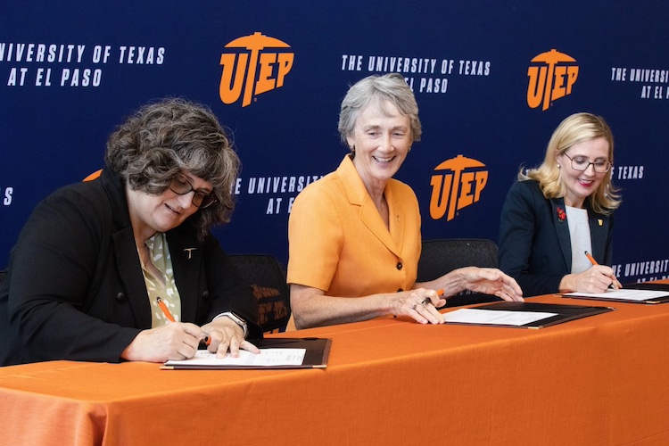 UTEP President Heather Wilson (center) signs a collaboration agreement between the Department of Defense and UTEP, while Kara Perry (left), Ph.D., Education and Workforce Development Co-Lead for the Office of the Under Secretary of Defense for Research and Engineering Trusted and Assured Microelectronics program and Meredith Dyck (right), Ph.D., Chief Strategist for Microelectronics at the National Security Agency (NSA) serve as witnesses. The new collaboration will support research and training to strengthen the nation’s leadership in semiconductor, or microchips, technology. 