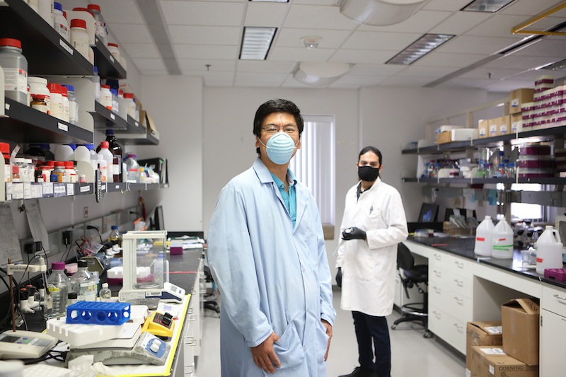  Jianjun Sun, Ph.D. left, associate professor in The University of Texas at El Paso Department of Biological Sciences, and Javier Aguilera, a doctoral student, stand in Sun's lab in the Bioscience Research Building. The pair worked with other biology students and faculty members to detail how a bacterial protein dictates the course of the bacterial pathogen that causes tuberculosis in a recently published article in the Journal of Biological Chemistry, a publication of the American Society of Biochemistry and Molecular Biology. Photo: J.R. Hernandez / UTEP Communications 