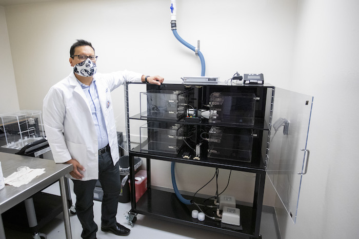 Ian Mendez, Ph.D., UTEP assistant professor of pharmacy, is using a vapor inhalation system to investigate the effects of nicotine vapor exposure on adolescent behavior. Photo: Ivan Pierre Aguirre / UTEP Communications 