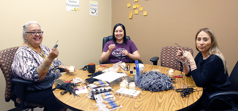 Faculty, staff and students from The University of Texas at El Paso, have volunteered their time to help the migrants who cross the border into El Paso from Mexico and countries in Central America. A group of volunteers including Yolanda Leyva, Ph.D., left, associate professor of history and director of UTEP's institute of Oral History, made shoelaces recently for refugees who must surrender their shoelaces and belts when they enter the custody of U.S. authorities. Photo by Laura Trejo / UTEP Communications 